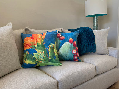 The Ahead of Its Time and Fruit of the Opuntia decorative pillows on a couch