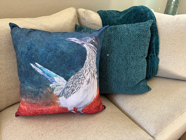 The Roadrunner throw pillow on a living room couch.