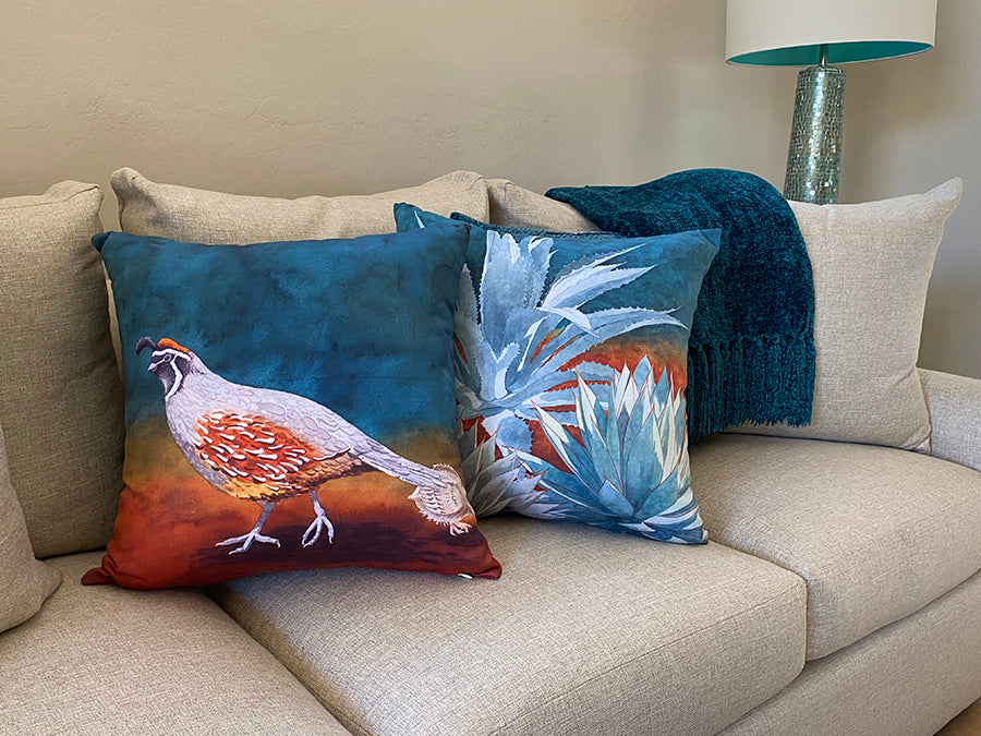 The Follow the Leader and All in the Family decorative pillows on a couch