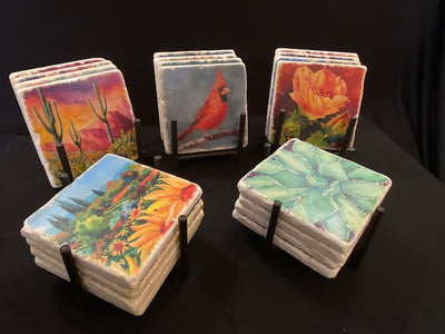All 5 collections of Heidi Rosner coasters shown in iron stands.