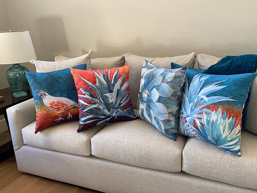 The Follow the Leader, Stick With Me, and All in The Family decorative pillows on a couch