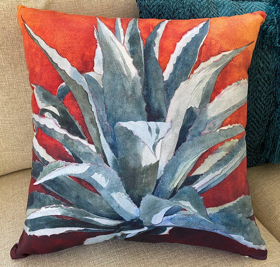 Tequila Sunrise decorative pillow on a couch